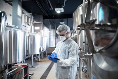 Technician reading a report in a lab as a part of Kiwa HACCP certification