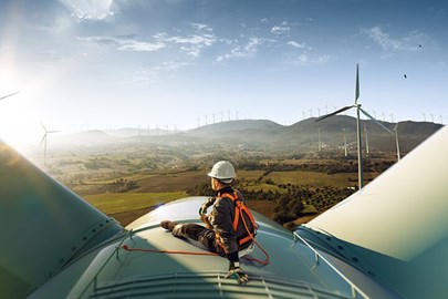 Worker sitting on a windmill